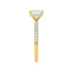 This elegant princess cut triple pavé shoulder set engagement ring features a glittering secret hidden halo that can only be seen from the side profile, adding extra sparkle to the best selling solitaire. Crafted in luxurious 18k Yellow Gold this ring truly glitters from every angle.